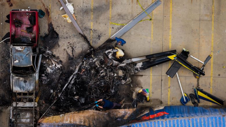 In this aerial view, people investigate the aftermath of a news helicopter crash in Chatsworth, a neighborhood in Los Angeles, on Wednesday, Sept. 16.