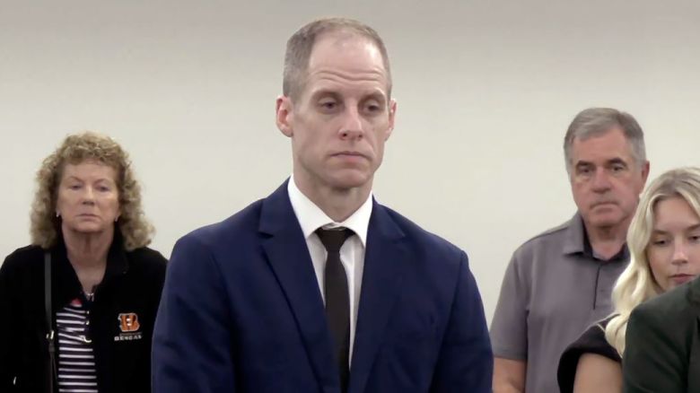 Caleb Flynn stands appears in court Friday as he stands trial on charges connected to the killing of his wife, Ashley.